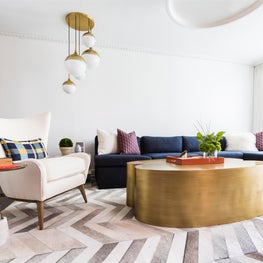 Portfolio: Contemporary home with bold pops of brass and a contrasting blue sectional