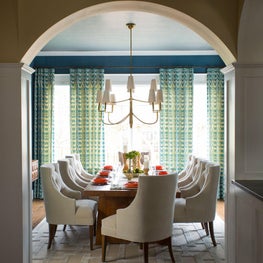 Transitional dining room with arched doorway