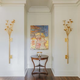 Gold Gilded Sconces Flanking art in foyer 