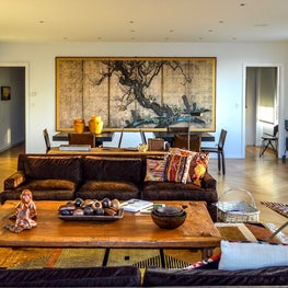 Penthouse Living Room with Warm Brown Tones, Asian Antiques and a Modern Mix