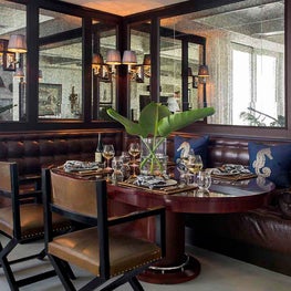 French Bistro-Inspired Leather Banquette Dining Area with Antiqued Mirror Panels