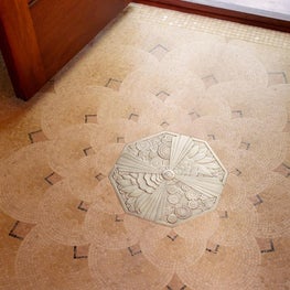 Customized nickel-bronze floor medallion surrounded by mosaic Israeli limestone