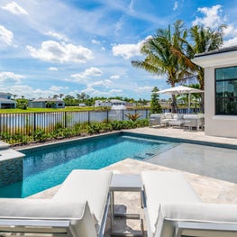 SLECONTEMPORARY METALLIC RESIDENCE luxury pool, coastal living, modern inground pool, hot tub, outdoor white lounge chairs