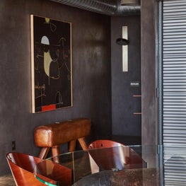 Vintage curved wood chairs surrounding table made from reclaimed factory pipes