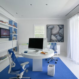 Tropical minimalism in a Palm Beach home office that opens fully to the gardens.