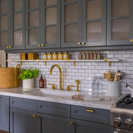 Subway Tile Kitchen with Blue Cabinetry and Brass Hardware