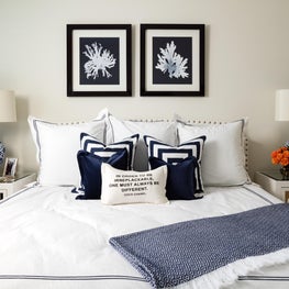 This white contemporary bedroom is trimmed with deep blue details.