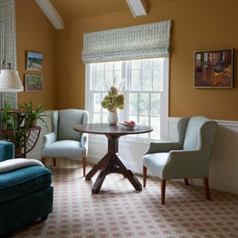 Glenview Family Room. Teal, tan and red scheme with white wainscoting, tripod game table & wing chairs.