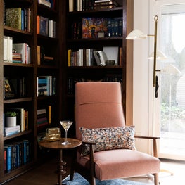 Portfolio: Mid-century modern study room with salamander color reupholstered chair and white floor lamp