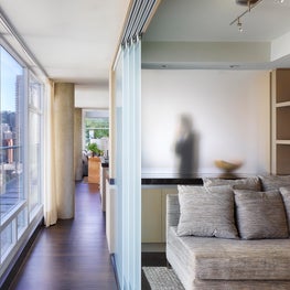 Guest bedroom partitioned with acid etched glass sliding doors