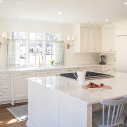 White Marble Kitchen with Brass Accents
