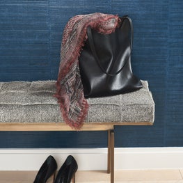 Detail in Tribeca foyer with textured blue wallpaper and fur bench