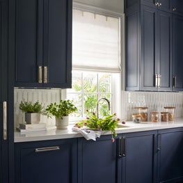 Dressed in a sophisticated shade of blue and adorned with mixed metals, the Colonial Drive butler’s pantry is as elegant as it is functional.