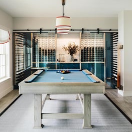 Contemporary pool room with attached wine cellar