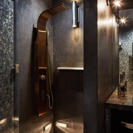 Plastered shower walls, marble vanity, & curved rainhead shower spa system