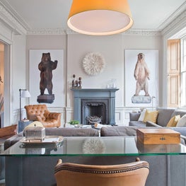 Bear with me! / The fireplace of this parlor is flanked by real life sized photos and peppered with a collection of lovely antiques. An overscaled yellow lampshade brings a pop of joy and brightness throughout the seasons.