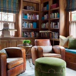 Cozy Library & Office with Leather Lounge Chairs and Upholstered Foot Stool
