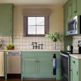 Contemporary farmhouse with green painted cabinets, rustic touches