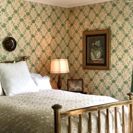 Historic Colonial Cottage with restored antique wallpaper, treasured family heirlooms, and traditional bed linens is designed for charm and comfort.