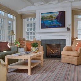 Color,texture and art work make this reonovated family room "read"happy and warm