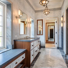 A modern mix of marbles with modern detailing and industrial fixtures