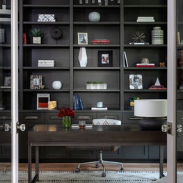 Portfolio: Modern home office with dark bookshelf and chandelier