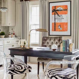 Eclectic transitional home office with zebra print chairs and hermes orange art