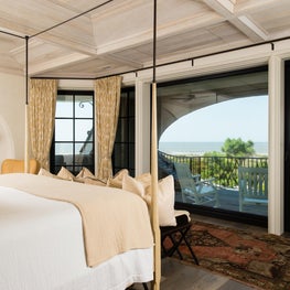 Oceanfront Bedroom with White Washed Ceiling and Shingled Arch Balcony