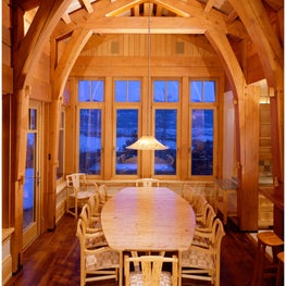 A custom breakfast table and chairs by artisan Hank Gilpin are made to fit this Colorado home along with reclaimed speckled elm wood and a hand-blown pendant light by a glass artist.   