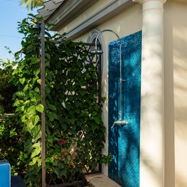 A secluded outdoor shower in the garden of an oceanfront Palm Beach Estate