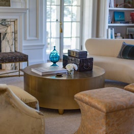 Living Room with Vladimir Kagan Sofa, Fortuny Stools and Round Brass Coffee Table