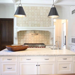 White and gray kitchen with custom tiled hood.  