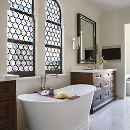 Custom bottle glass windows adds character to this master bathroom