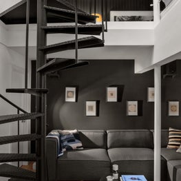 Grey & white modern lounge with spiral staircase, large sale art