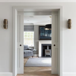 Looking through ! entrance hall to library with limestone fireplace 