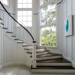 Stairs with view of Windows