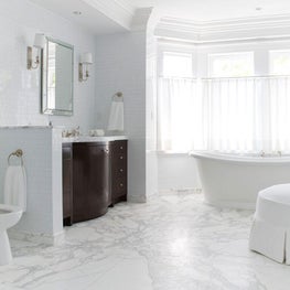 Marble tile gives the expansive master bath a spa-like feel.