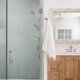 Elegant Coastal White Bathroom with Wood Cabinets
