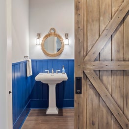 Nautical powder room with stunning barndoor