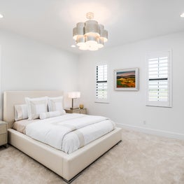 SLEEK CONTEMPORARY METALLIC RESIDENCE neutral guest bedroom, sculptural metalic chandelier pendant lamp, white linens, upholstered headboard