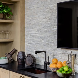 Suburban lounge with custom stone and wood bar 