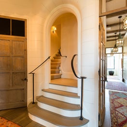 Arched Back Stair Opening with Gapped Boards and Iron Railing