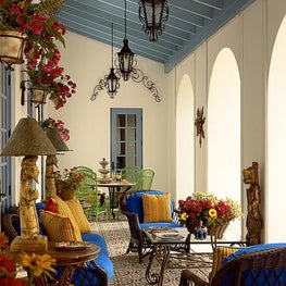 This exterior room is grounded with colorful Mexican tiles and blue cushions.
