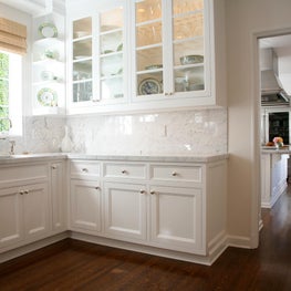 Butlers Pantry with white marble, wood floors and displaying Hermes China