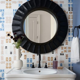 Simple updates - new wallcoverings, mirror, and fixtures - to this powder bath made all the difference.