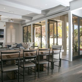 Contemporary living room with custom French doors to outdoor space