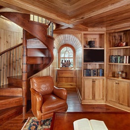 Butternut Wood Paneled Library with Wood Spiral Stair and Arched Window