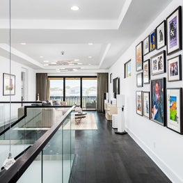 SLEEK CONTEMPORARY METALLIC RESIDENCE gallery wall, dark hardwood floors, white walls, coffered ceilings, modern chandelier