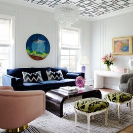 living room with traditional applied moldings and wallpapered ceiling
