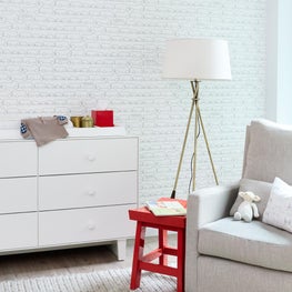 Bright Manhattan nursery with red accents and Sissy & Marley kids wallpaper